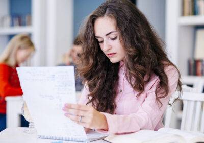 student-reading-notes-library